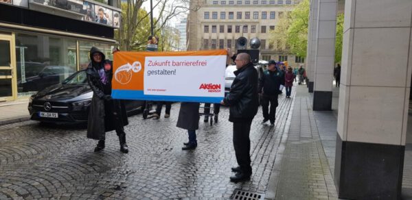 Start des Demonstrationszuges mit einem Banner der Aktion Mensch: "Zukunft barrierefrei gestalten!"